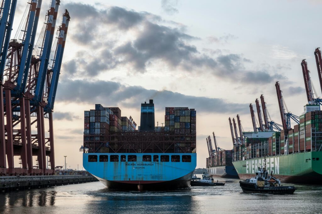 Container ships docked at a major port, illustrating global trade and supply chain disruptions in the new normal